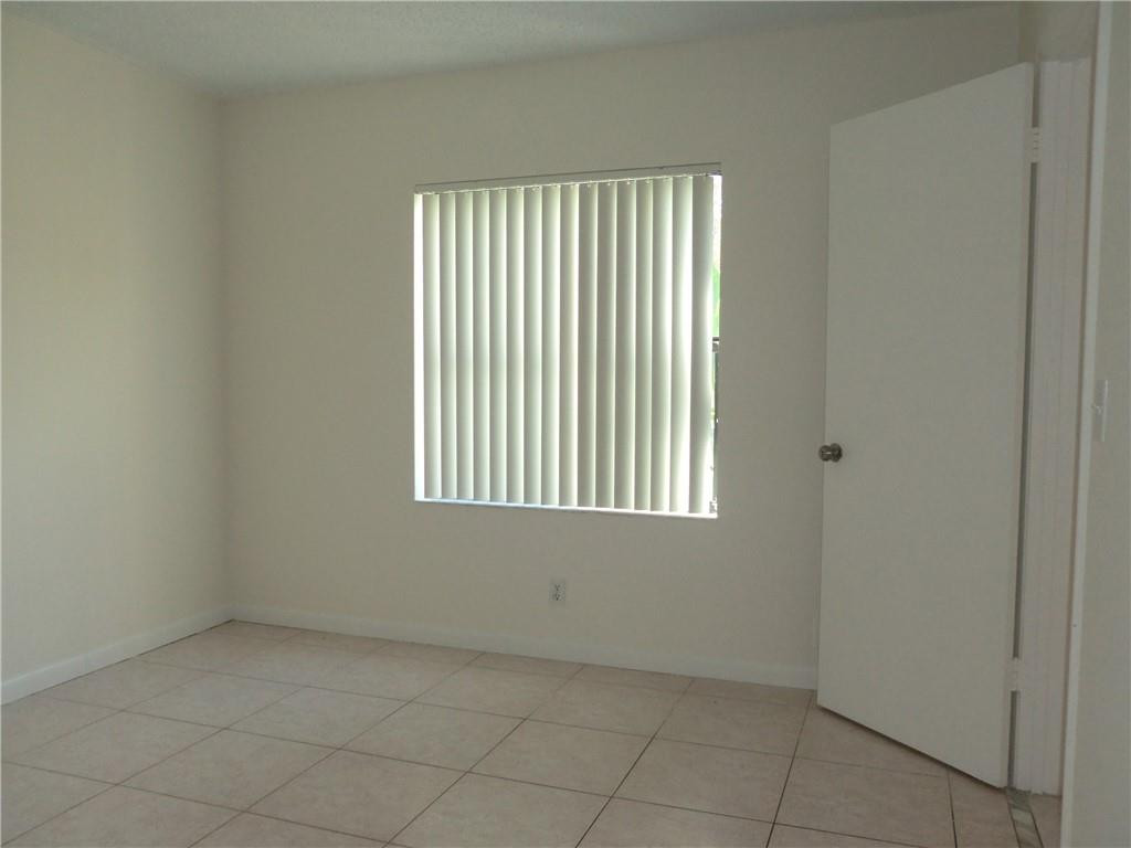 6796 Palmetto Circle South, Unit 101 Boca Raton, FL 33433 - Photo 12 of 29 an empty room with a window