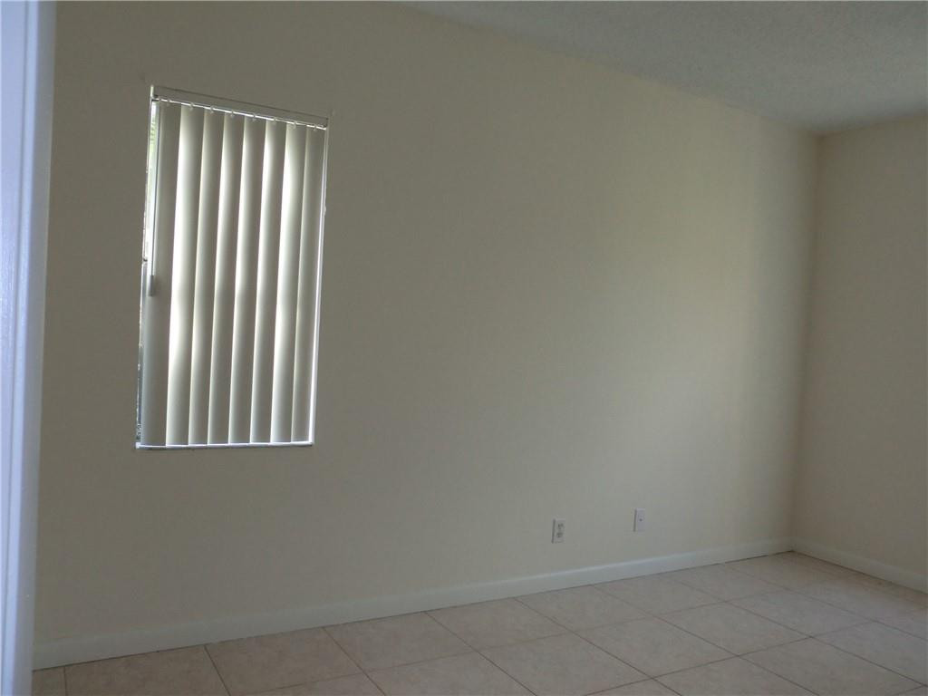 6796 Palmetto Circle South, Unit 101 Boca Raton, FL 33433 - Photo 13 of 29 an empty room with a window