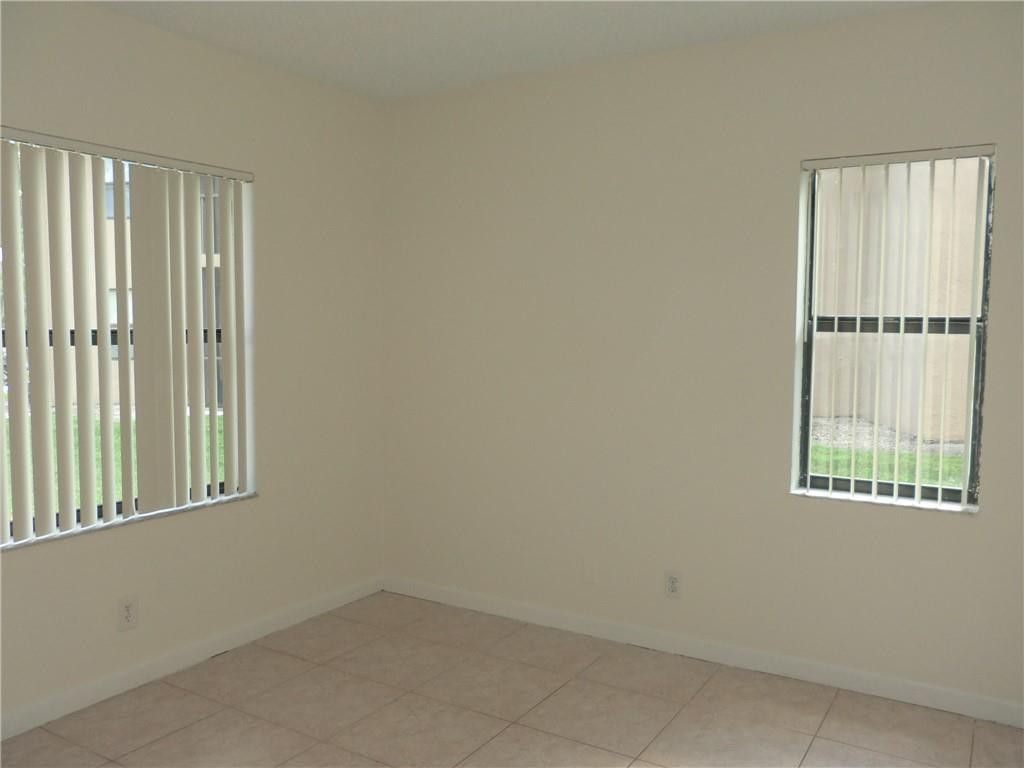 6796 Palmetto Circle South, Unit 101 Boca Raton, FL 33433 - Photo 18 of 29 an empty room with windows