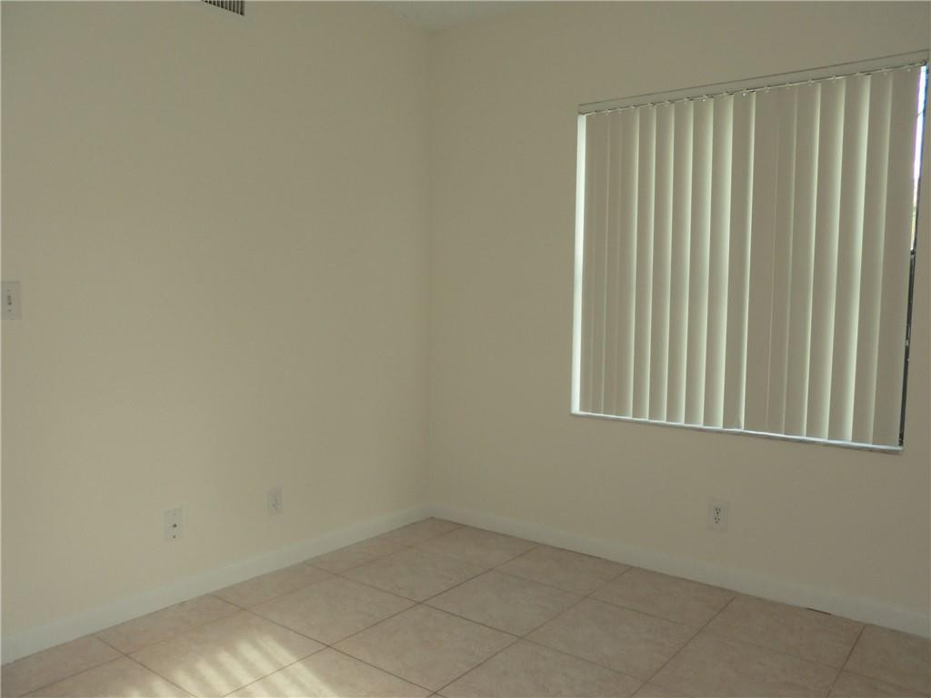 6796 Palmetto Circle South, Unit 101 Boca Raton, FL 33433 - Photo 20 of 29 an empty room with a window