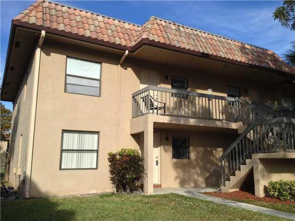 6796 Palmetto Circle South, Unit 101 Boca Raton, FL 33433 - Photo 24 of 29 a front view of a house with garden