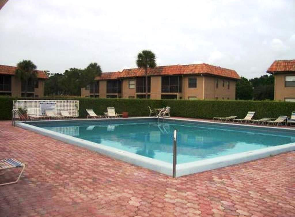 6796 Palmetto Circle South, Unit 101 Boca Raton, FL 33433 - Photo 26 of 29 a view of a house with a yard