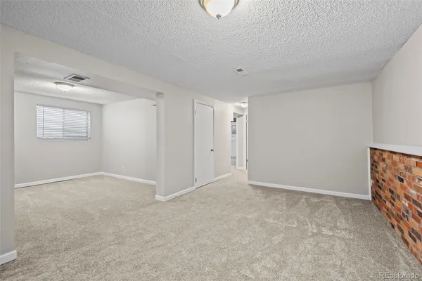 a view of an empty room and a window