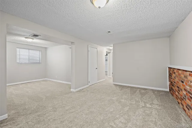 a view of an empty room and a window