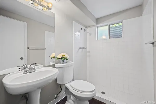 a bathroom with a sink toilet and a mirror