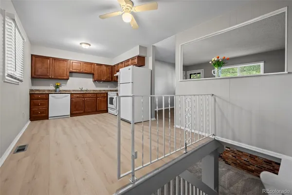 a kitchen with stainless steel appliances granite countertop a refrigerator and a stove top oven
