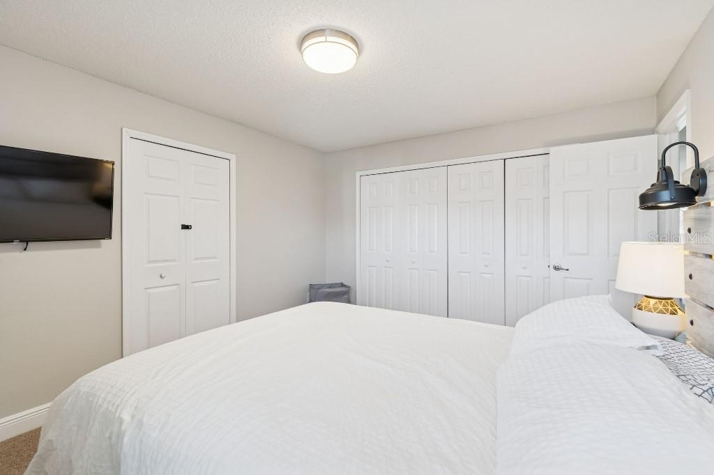 13125 Wilcox Road, Unit 6205 Largo, FL 33774 - Photo 21 of 48 a bedroom with a bed and a flat screen tv