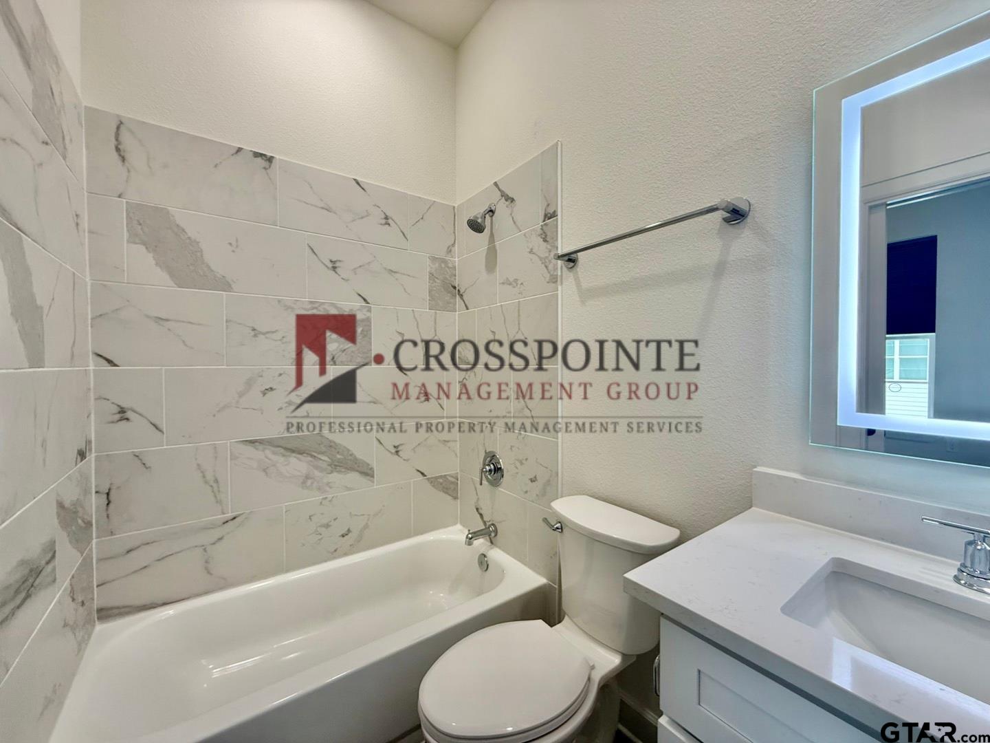 548 West Erwin Street Tyler, TX 75702 - Photo 25 of 27 a bathroom with a sink a toilet and a bathtub