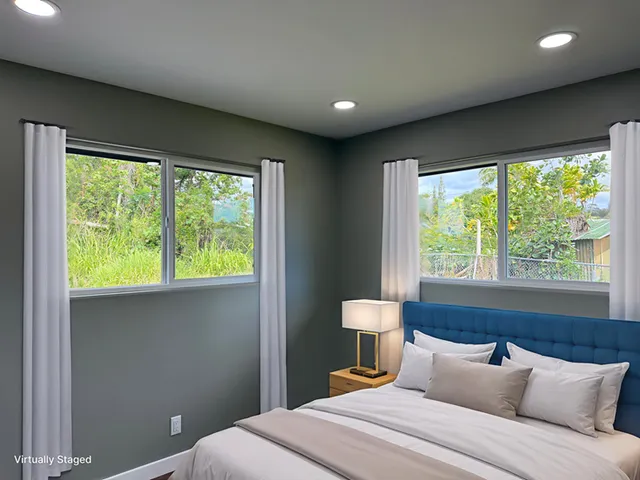 a bedroom with a bed and a large window