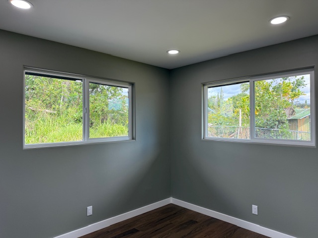144 Chong Street Hilo, HI 96720 - Photo 15 of 28 a view of a big room with wooden floor and windows