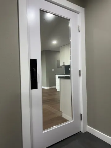 a kitchen with a sink a stove and white cabinets