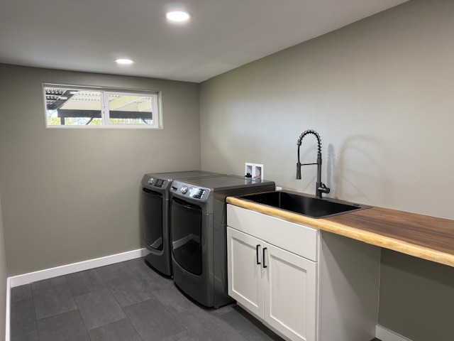144 Chong Street Hilo, HI 96720 - Photo 23 of 28 a kitchen with a sink a stove and white cabinets