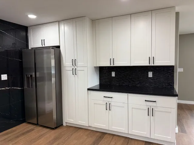 a kitchen with stainless steel appliances a refrigerator a stove a microwave and cabinets