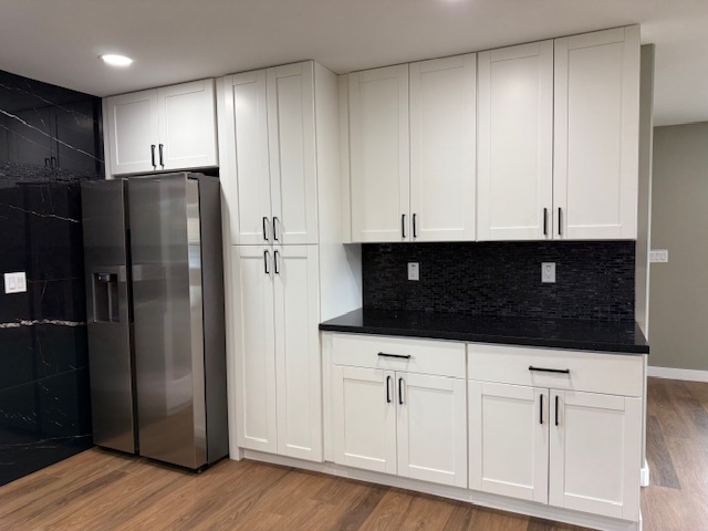 144 Chong Street Hilo, HI 96720 - Photo 3 of 28 a kitchen with stainless steel appliances a refrigerator a stove a microwave and cabinets