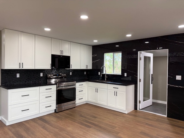144 Chong Street Hilo, HI 96720 - Photo 7 of 28 a kitchen with granite countertop a sink and a stove top oven