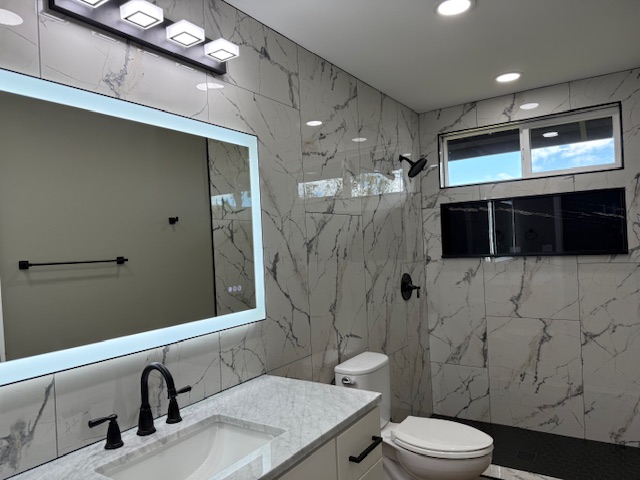 144 Chong Street Hilo, HI 96720 - Photo 8 of 28 a bathroom with a sink a toilet and shower