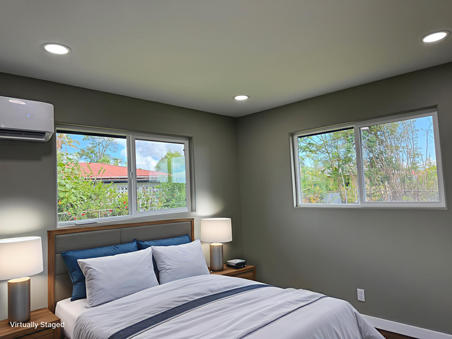 144 Chong Street Hilo, HI 96720 - Photo 9 of 28 a bedroom with a bed and a large window