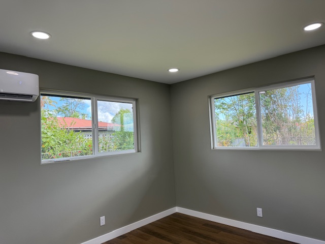 144 Chong Street Hilo, HI 96720 - Photo 10 of 28 a view of a big room with wooden floor and windows