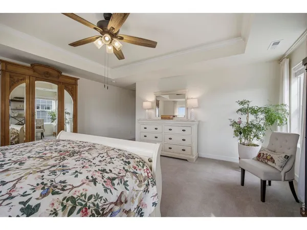 a bed room with a bed and a chair