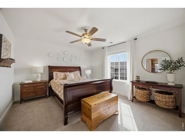 a living room with furniture a bed and a chandelier
