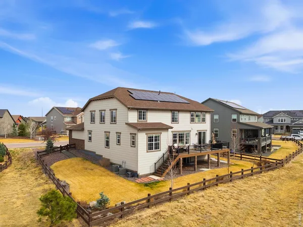 a view of a house with large pool and a yard