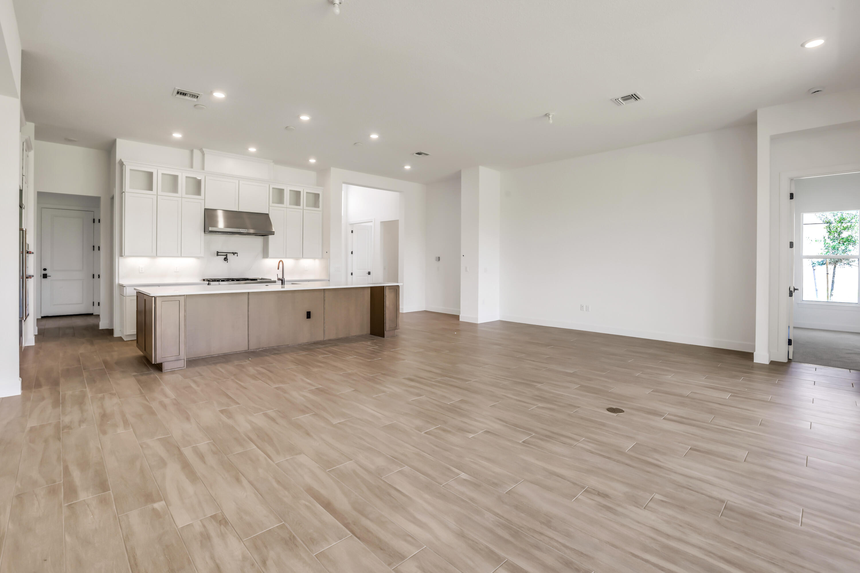20161 Southeast Bridgewater Drive Jupiter, FL 33458 - Photo 12 of 50 a large kitchen with a wooden floor and stainless steel appliances