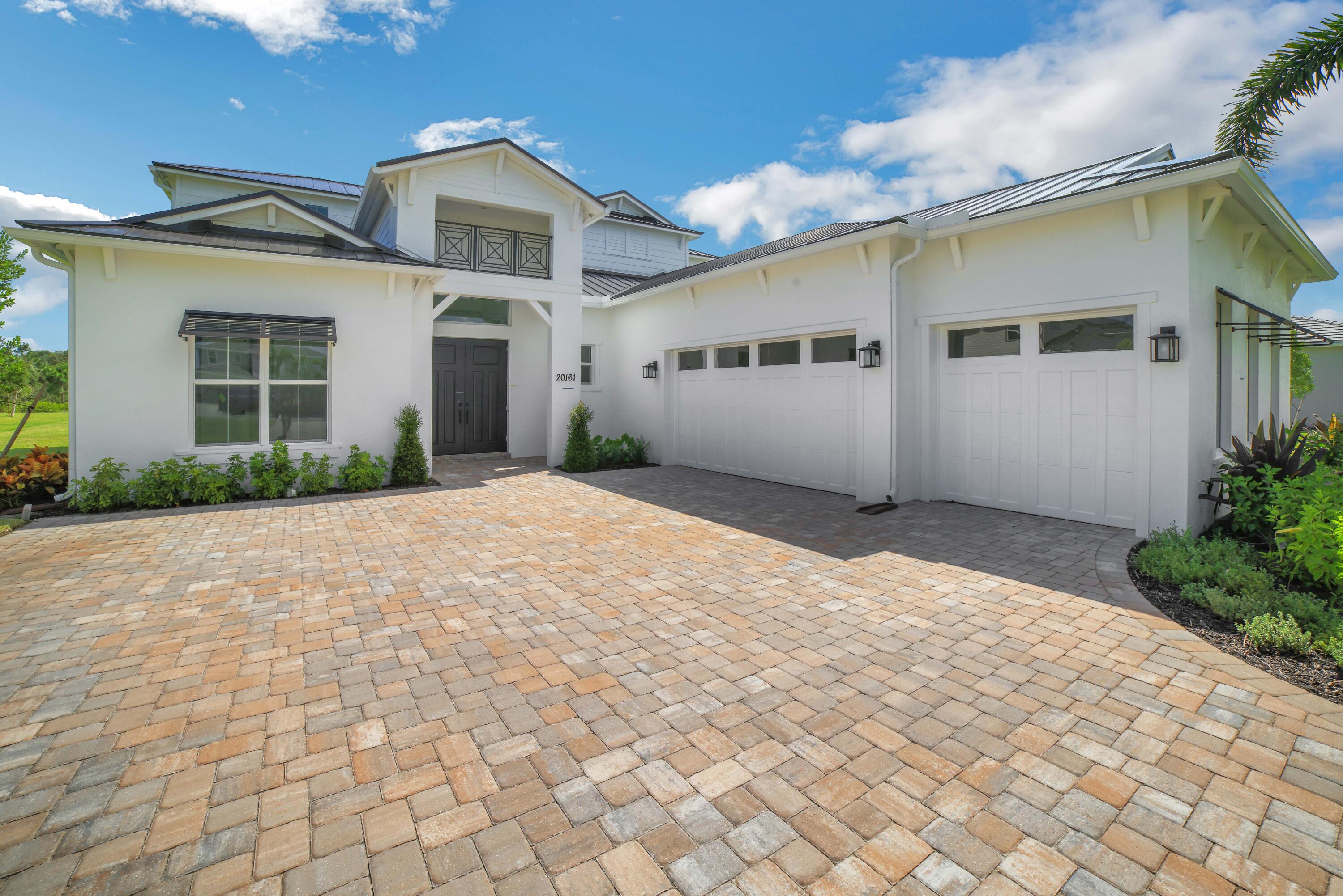 20161 Southeast Bridgewater Drive Jupiter, FL 33458 - Photo 2 of 50 a front view of a house with a yard