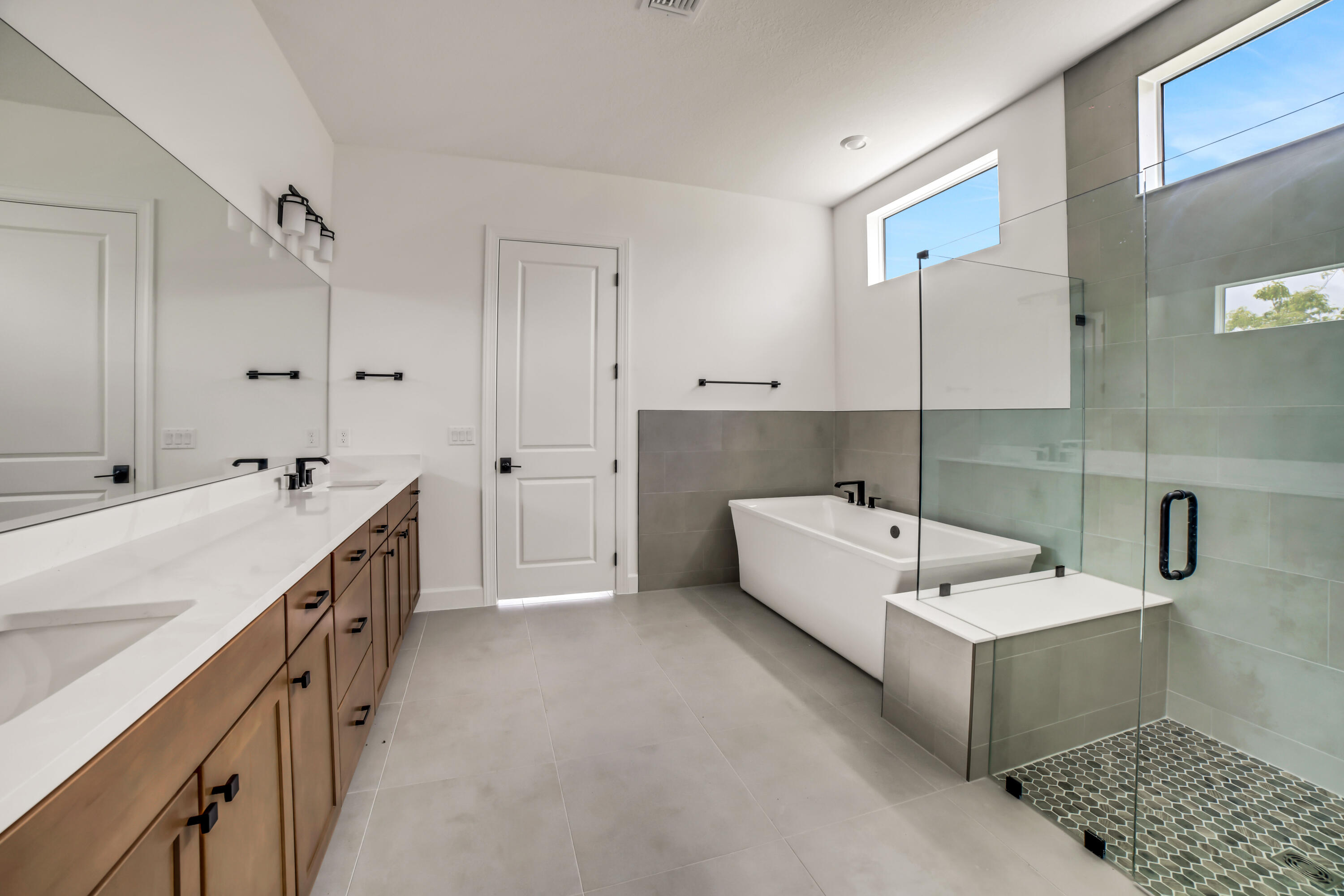 20161 Southeast Bridgewater Drive Jupiter, FL 33458 - Photo 28 of 50 a bathroom with a double vanity sink a mirror and a bathtub