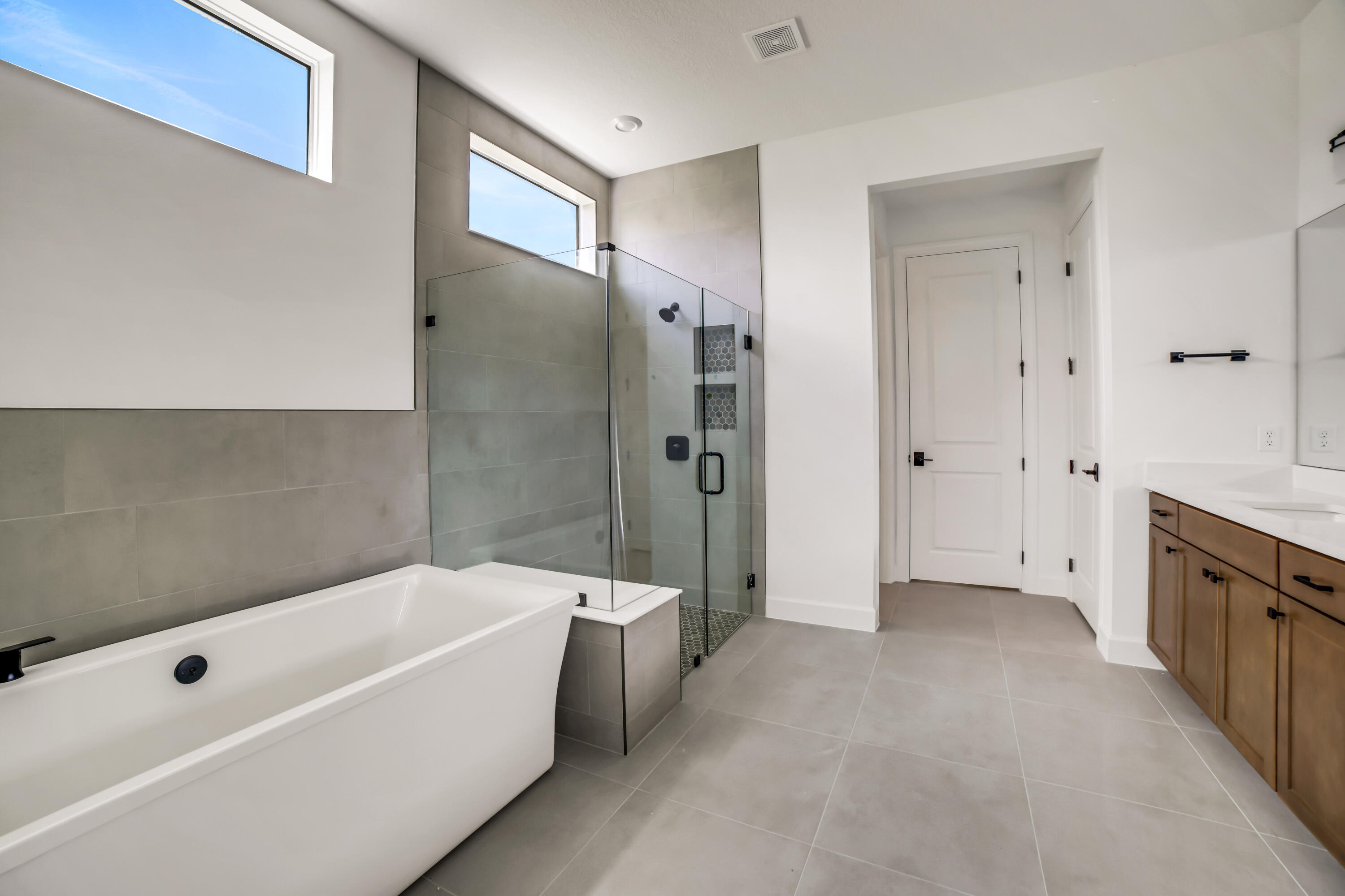 20161 Southeast Bridgewater Drive Jupiter, FL 33458 - Photo 29 of 50 a bathroom with a bathtub shower and a sink