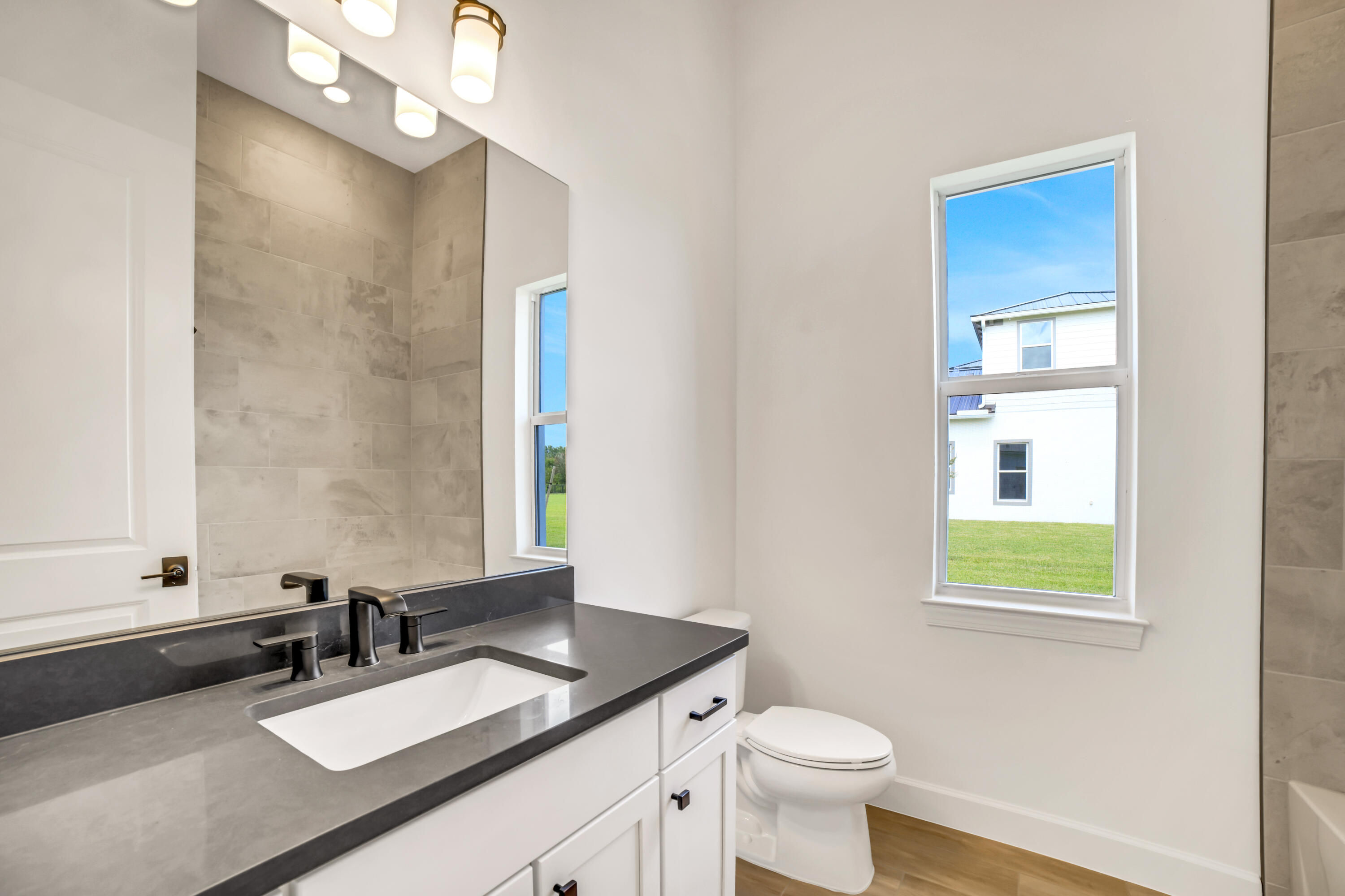 20161 Southeast Bridgewater Drive Jupiter, FL 33458 - Photo 45 of 50 a bathroom with a granite countertop sink toilet and mirror
