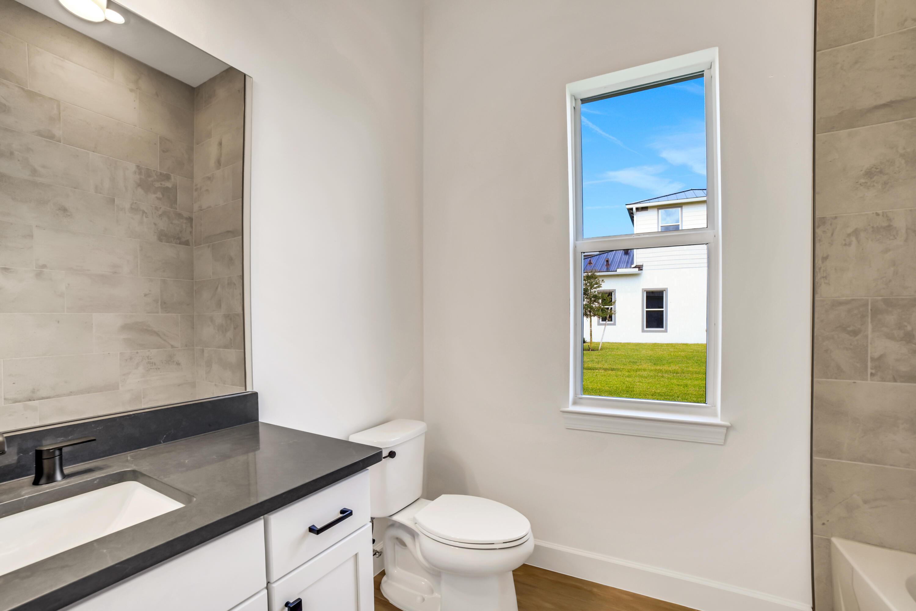20161 Southeast Bridgewater Drive Jupiter, FL 33458 - Photo 46 of 50 a bathroom with a sink a toilet and a window