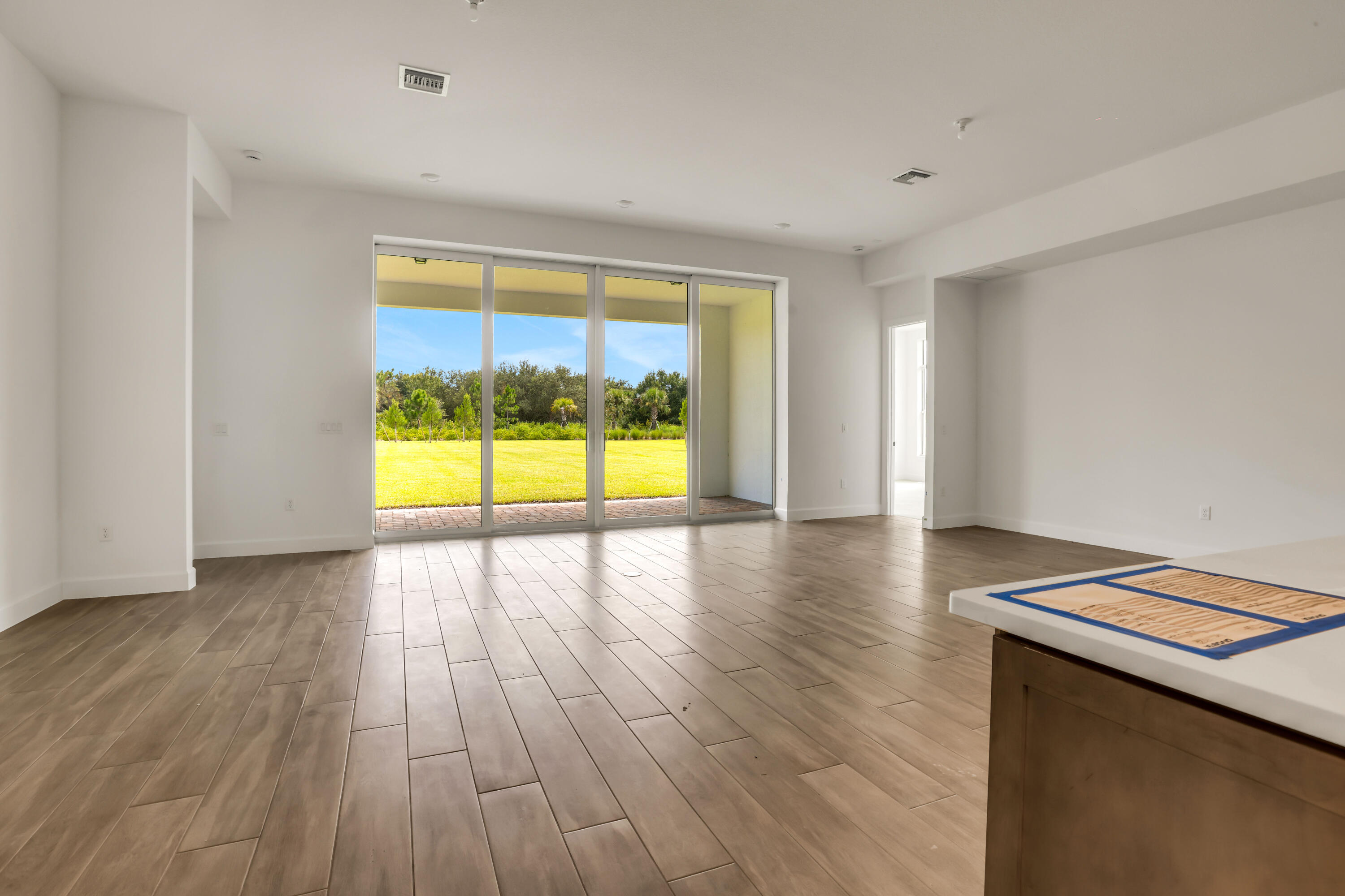 20161 Southeast Bridgewater Drive Jupiter, FL 33458 - Photo 5 of 50 a view of an empty room with wooden floor and a window