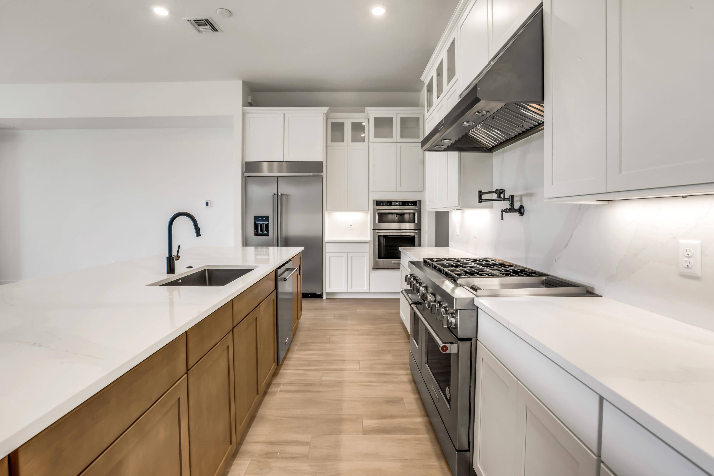 20161 Southeast Bridgewater Drive Jupiter, FL 33458 - Photo 7 of 50 a kitchen with stainless steel appliances granite countertop a sink stove and refrigerator