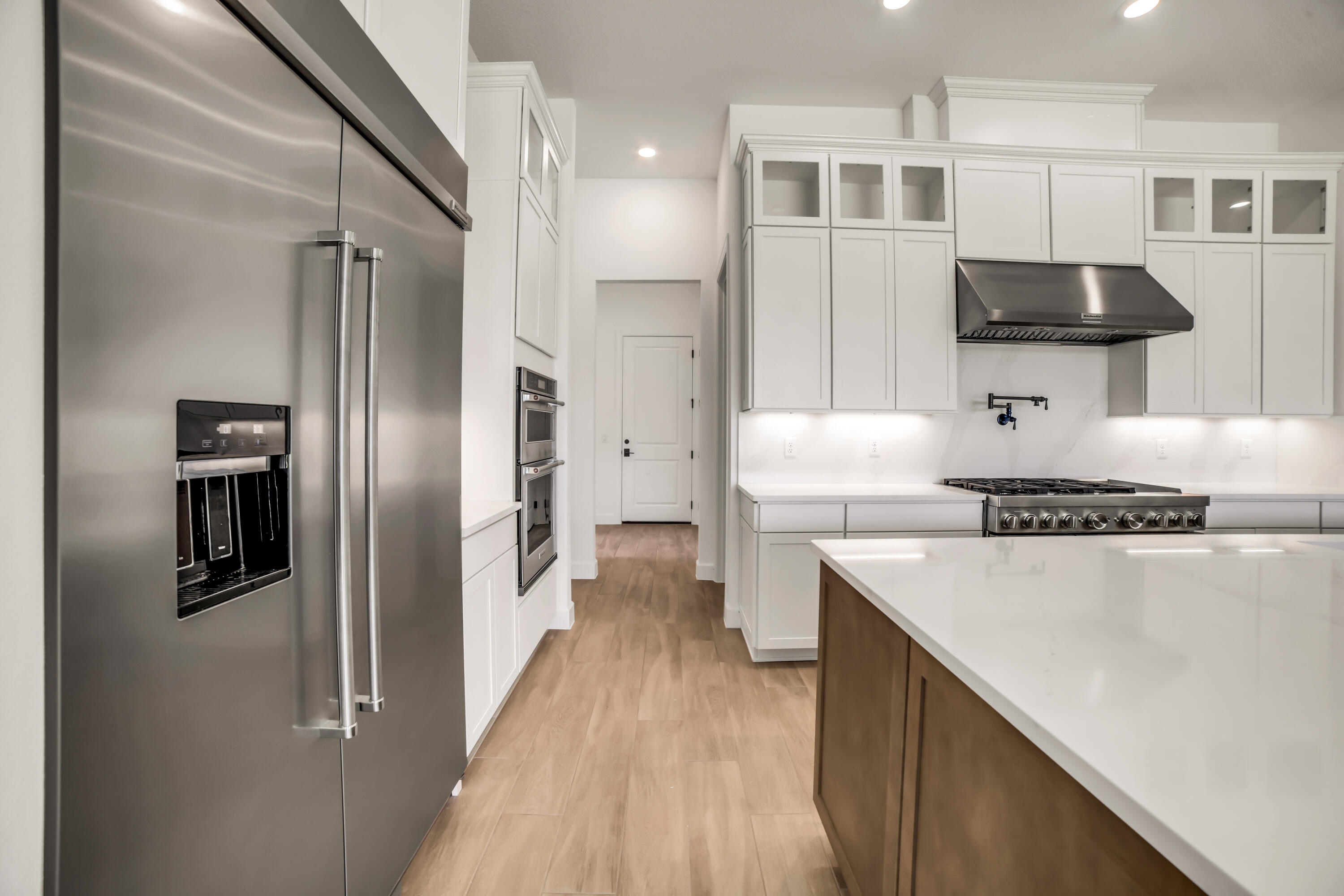 20161 Southeast Bridgewater Drive Jupiter, FL 33458 - Photo 9 of 50 a kitchen with stainless steel appliances a refrigerator and a stove top oven