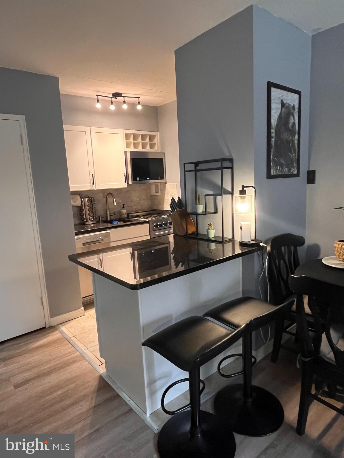 a kitchen with a sink cabinets and dining table