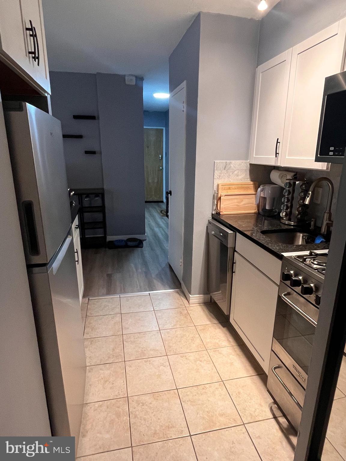 2101-17 Chestnut Street, Unit 319 Philadelphia, PA 19103 - Photo 12 of 33 a kitchen with stainless steel appliances a refrigerator and a sink