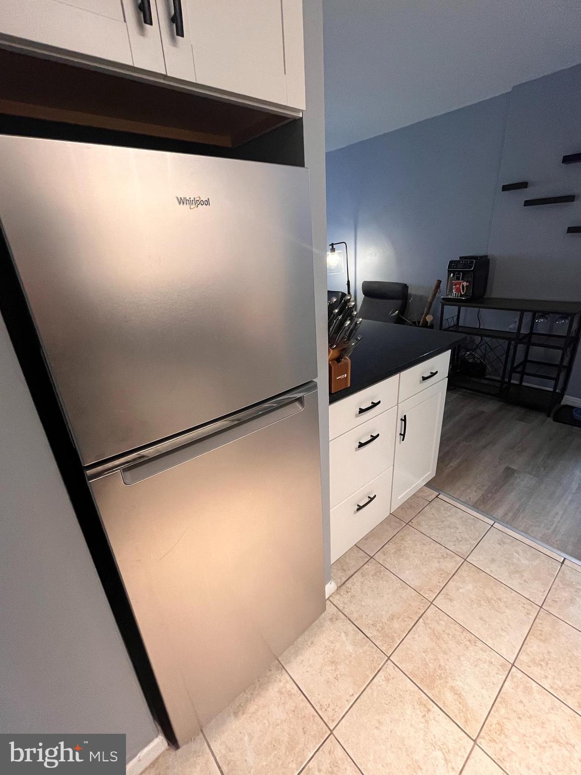 2101-17 Chestnut Street, Unit 319 Philadelphia, PA 19103 - Photo 13 of 33 a kitchen with cabinets and a refrigerator