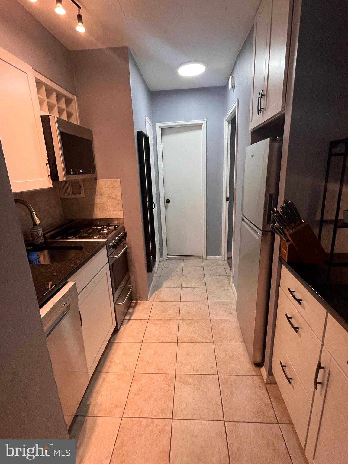 2101-17 Chestnut Street, Unit 319 Philadelphia, PA 19103 - Photo 15 of 33 a kitchen with stainless steel appliances a refrigerator and a sink