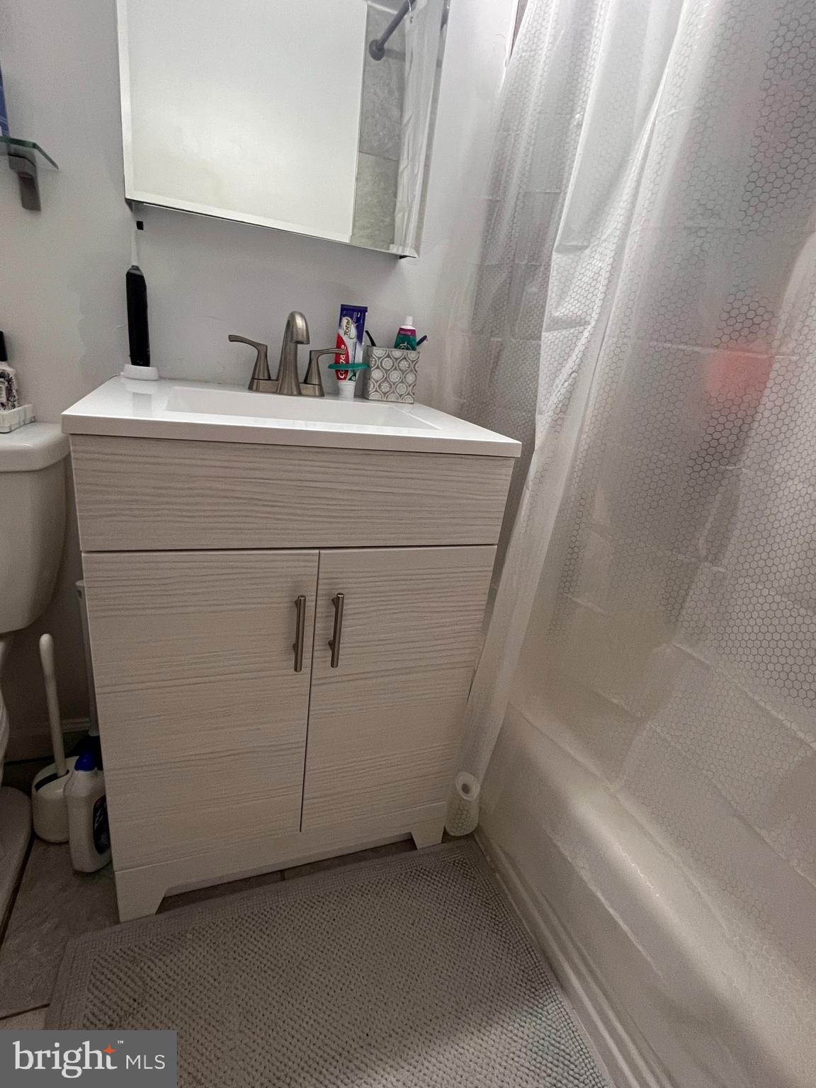 2101-17 Chestnut Street, Unit 319 Philadelphia, PA 19103 - Photo 25 of 33 a bathroom with a sink and a mirror