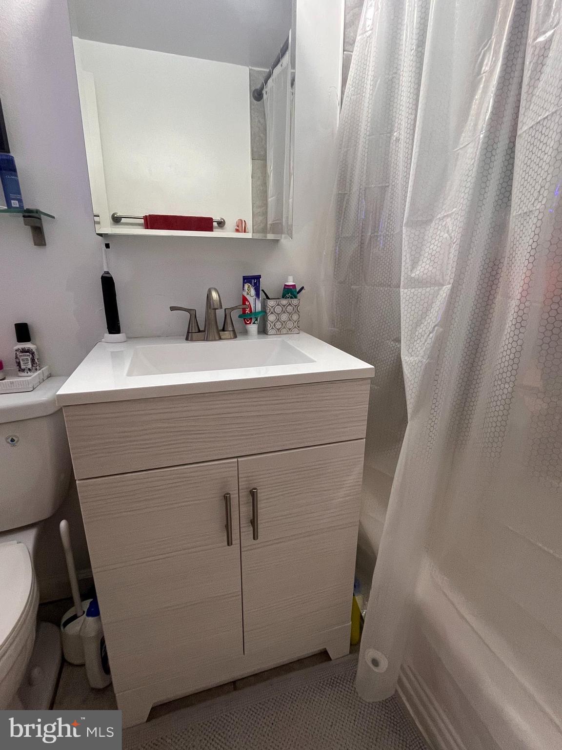 2101-17 Chestnut Street, Unit 319 Philadelphia, PA 19103 - Photo 28 of 33 a bathroom with a sink and a mirror