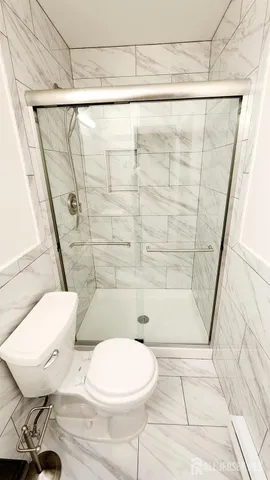 a bathroom with a toilet and a shower
