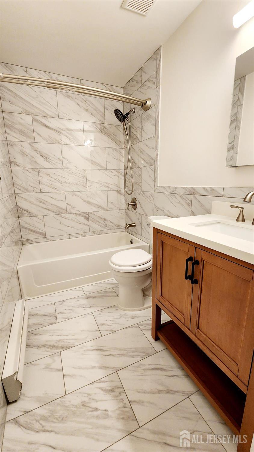 838 Vail Road, Unit A Monroe Township, NJ 08831 - Photo 25 of 34 a bathroom with a sink a toilet and shower