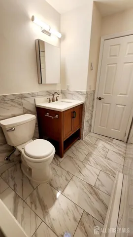 a bathroom with a sink a mirror and a toilet