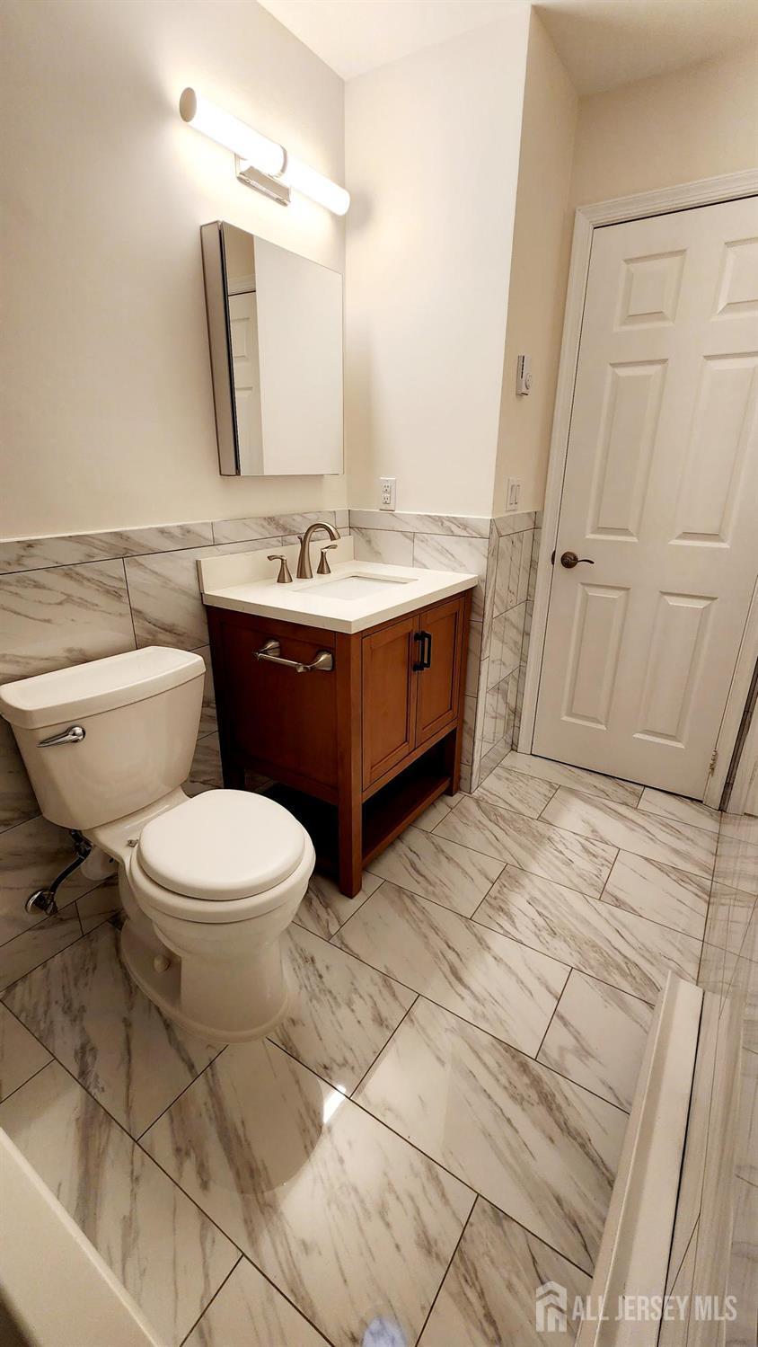 838 Vail Road, Unit A Monroe Township, NJ 08831 - Photo 27 of 34 a bathroom with a sink a mirror and a toilet