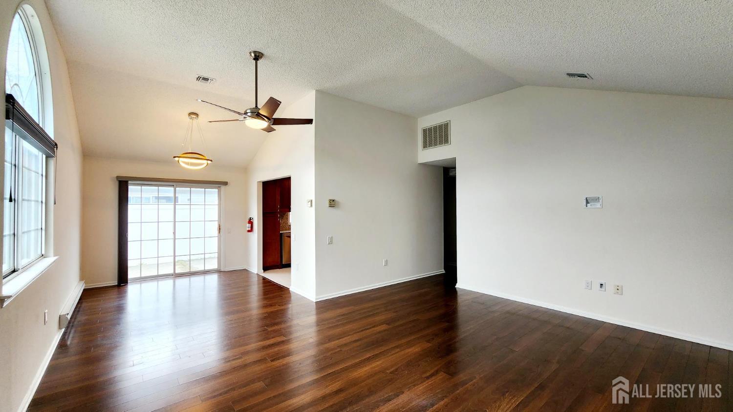 838 Vail Road, Unit A Monroe Township, NJ 08831 - Photo 4 of 34 an empty room with wooden floor and windows