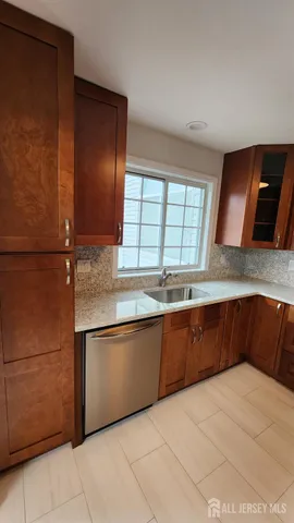 a kitchen with stainless steel appliances granite countertop a sink and cabinets
