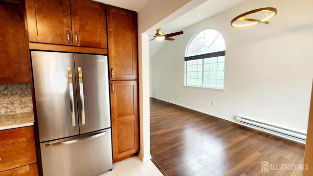 a view of a livingroom with wooden floor and a window