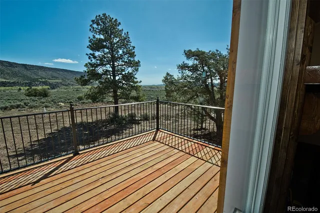 a view of balcony with wooden floor