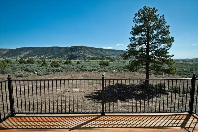 a view of an empty room with a window and a ceiling fan