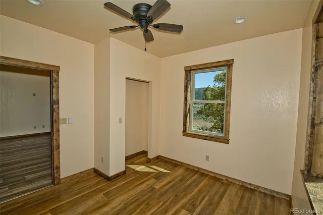 a view of empty room with wooden floor